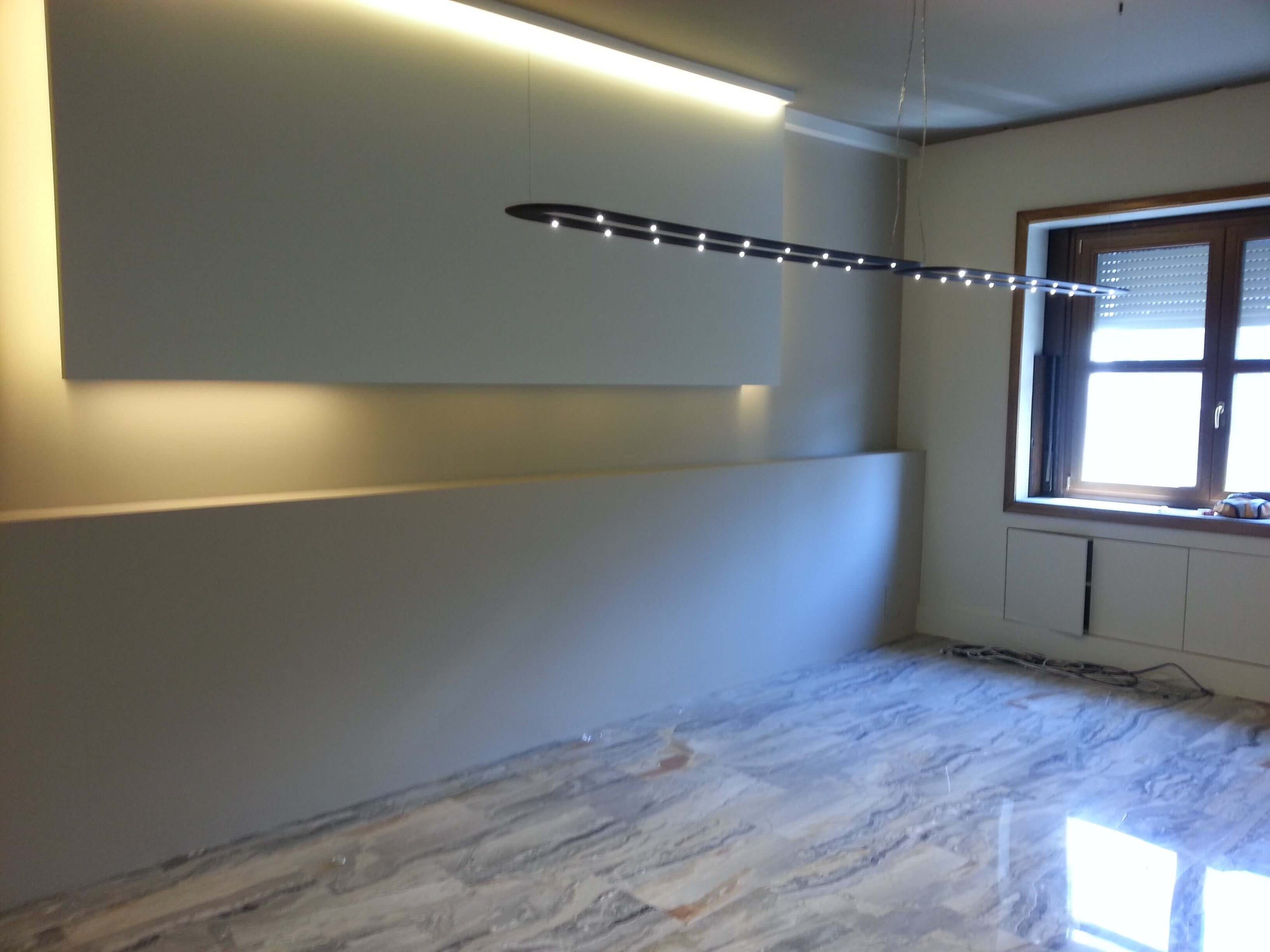 Modern electrical lighting installation in a newly renovated room with marble flooring by a professional elettricista impianti elettrici.